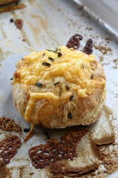 Cheesy Soda Scones Yield: 8 scones Prep Time: 10 min Cook Time: 15 min Wonderful little biscuit to serve with soup or stew. Change up the cheese and/or herbs as you see fit (think: Swiss, Gouda, rosemary, thyme!) Ingredients: 1 3/4 cups All Purpose flour 1/2 teaspoon salt 1/2 teaspoon baking soda 1/2 tablespoon finely chopped chives (plus a few extra) 1/2 + 1/3 cups buttermilk (measure 1/2, then measure 1/3) 1/3 cup grated sharp cheddar cheese
