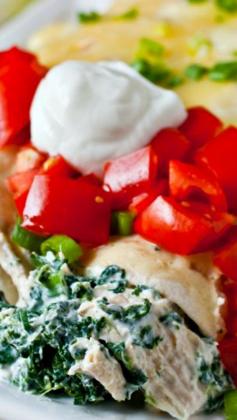 Skinny Creamy Chicken Enchiladas ~ Flour tortillas are filled with a healthy combination of boneless skinless chicken breast and cooked spinach that has been tossed with a light and super flavorful combination of low-fat sour cream, fat-free Greek yogurt, scallions, cumin and some diced green chili peppers.