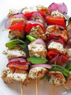 Marinated Greek Chicken Skewers | 1 1/2 lbs. boneless, skinless chicken breast, cut into 1-inch pieces 4 Tbsp. extra virgin olive oil, divided 4 garlic cloves, crushed 1-2 tsp. dried oregano 1 tsp. salt 1 tsp. ground black pepper 2 Tbsp. freshly squeezed lemon juice 1/2 red onion, quartered 1 green bell pepper, cut into 1 inch pieces 1 red bell pepper, cut into 1 inch pieces